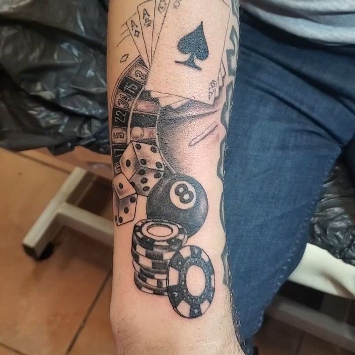 Vegas/gambling tattoo, 8-ball, dice, poker chips, roulette wheel, cards.